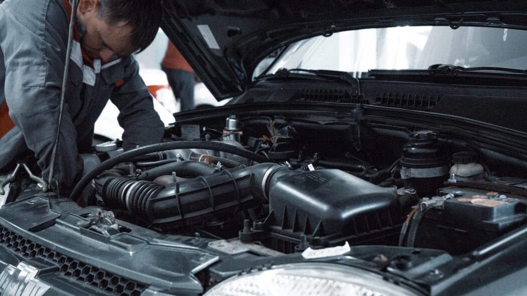 man repairing a car