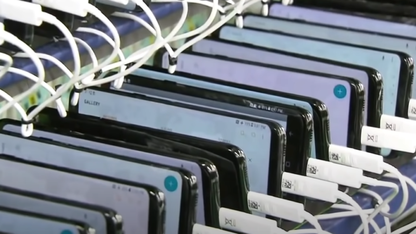 Phones lined up in a factory for charging