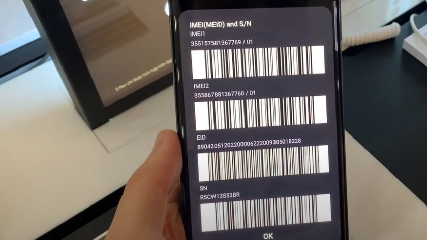 a smartphone displaying various codes and barcodes on its screen