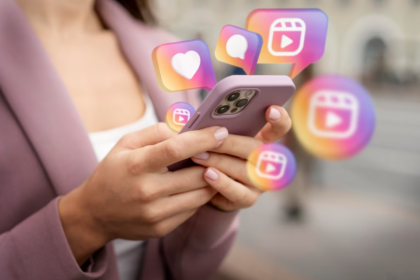 woman in a pink coat holds a phone with icons of Instagram above it