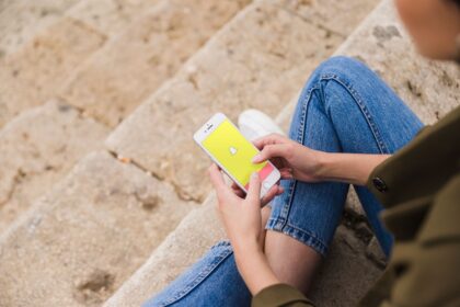 Woman sitting and using snapchat app